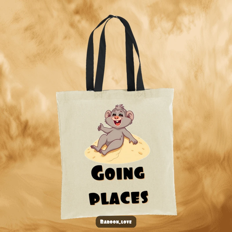 Funny tote bag featuring a giggling baboon sliding down a sandy dune, ideal for carrying your essentials with a smile.